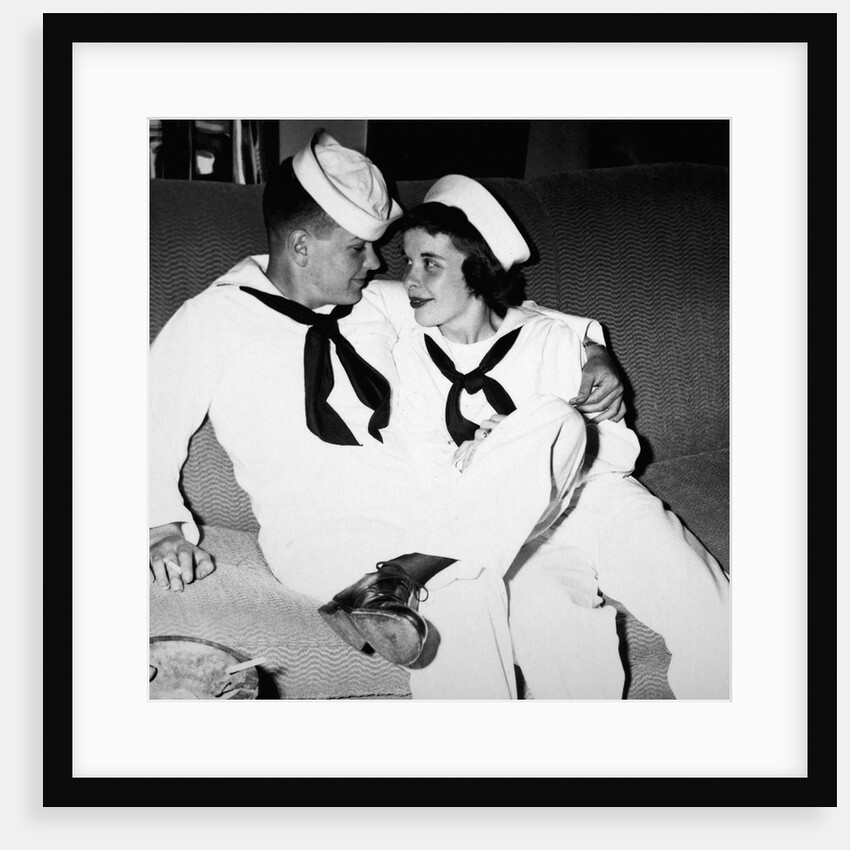 A sailor poses with his"sailor" girlfriend at a party, ca. 1955 by Anonymous