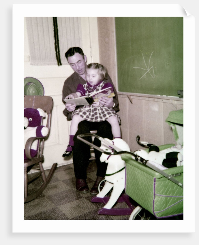 A father reads to his 4 year old daughter, ca. 1957 by Anonymous