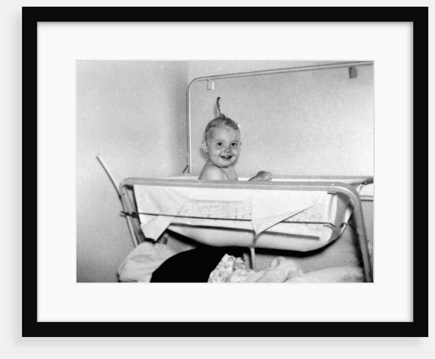 One year old baby girl enjoys her bath, ca. 1953 by Anonymous