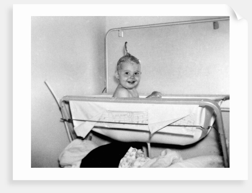 One year old baby girl enjoys her bath, ca. 1953 by Anonymous