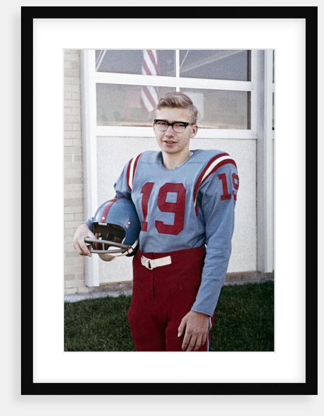 Fifteen year old high school football player portrait outside the school, ca. 1961 by Anonymous