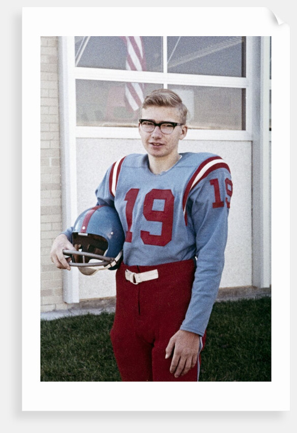 Fifteen year old high school football player portrait outside the school, ca. 1961 by Anonymous