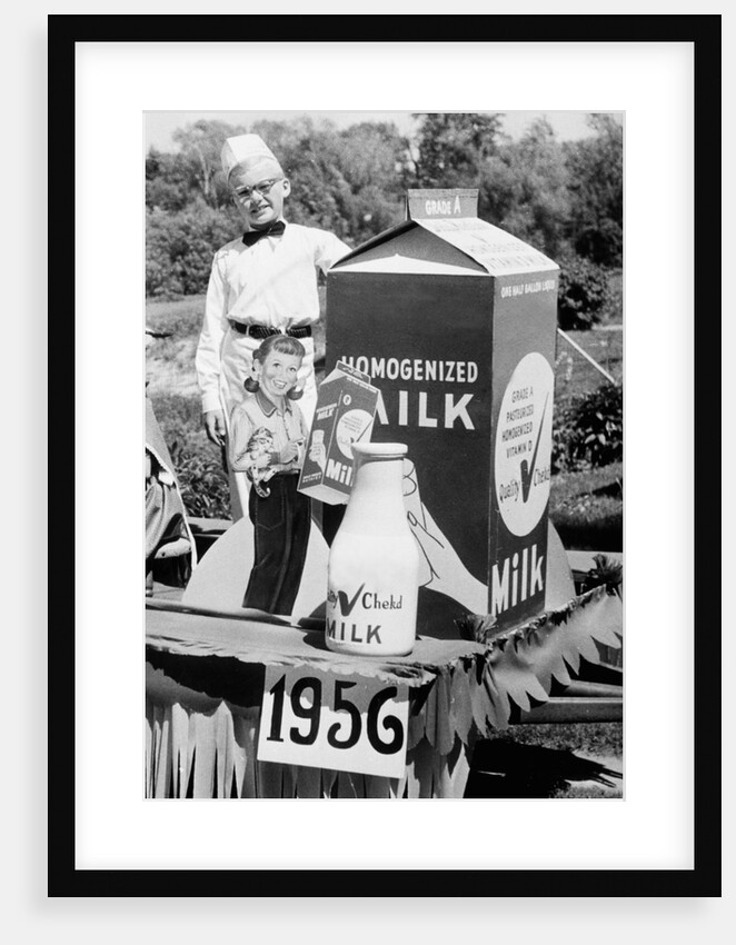 Ten year old boy rides on a parade float promoting milk in Wisconsin, ca. 1956 by Anonymous