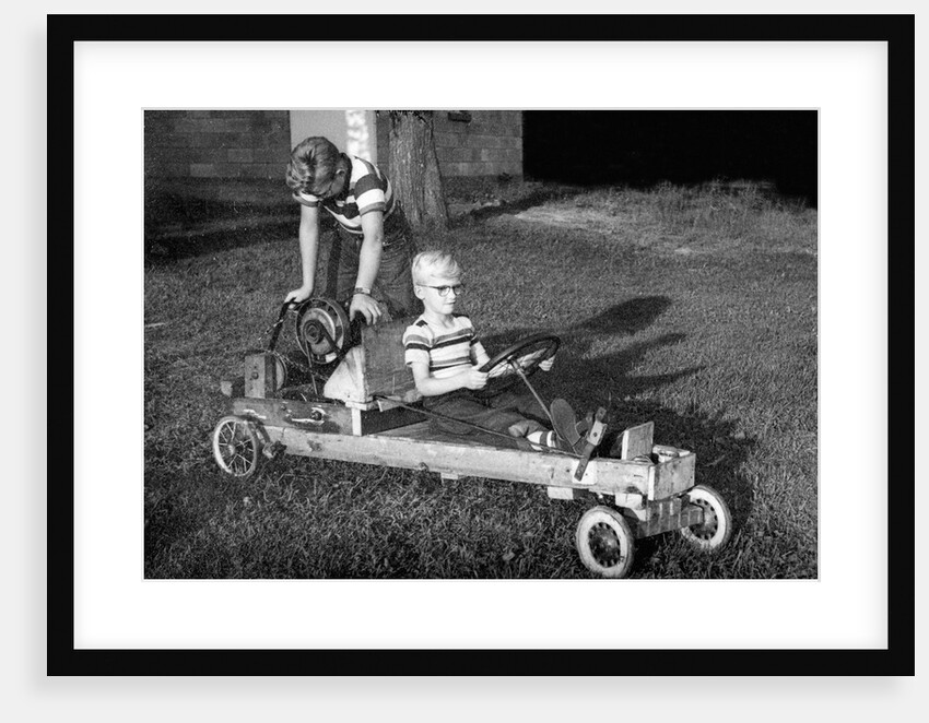 Brothers play with their homemade go cart, ca. 1955 by Anonymous