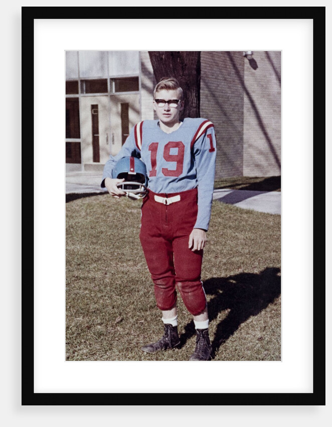 Fifteen year old high school football player portrait outside the school, ca. 1961 by Anonymous