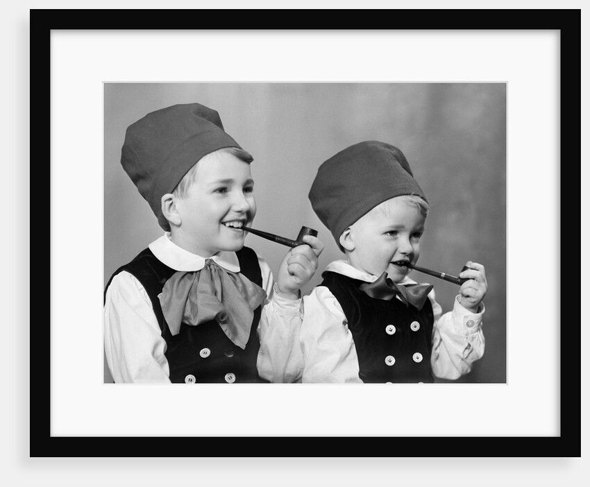 Two brothers in Bavarian costumes pretend to smoke pipes, ca. 1947 by Anonymous