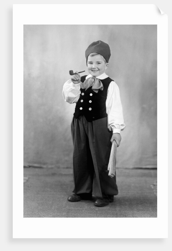 Six year old boy in Bavarian costume holds a pipe, ca. 1947 by Anonymous