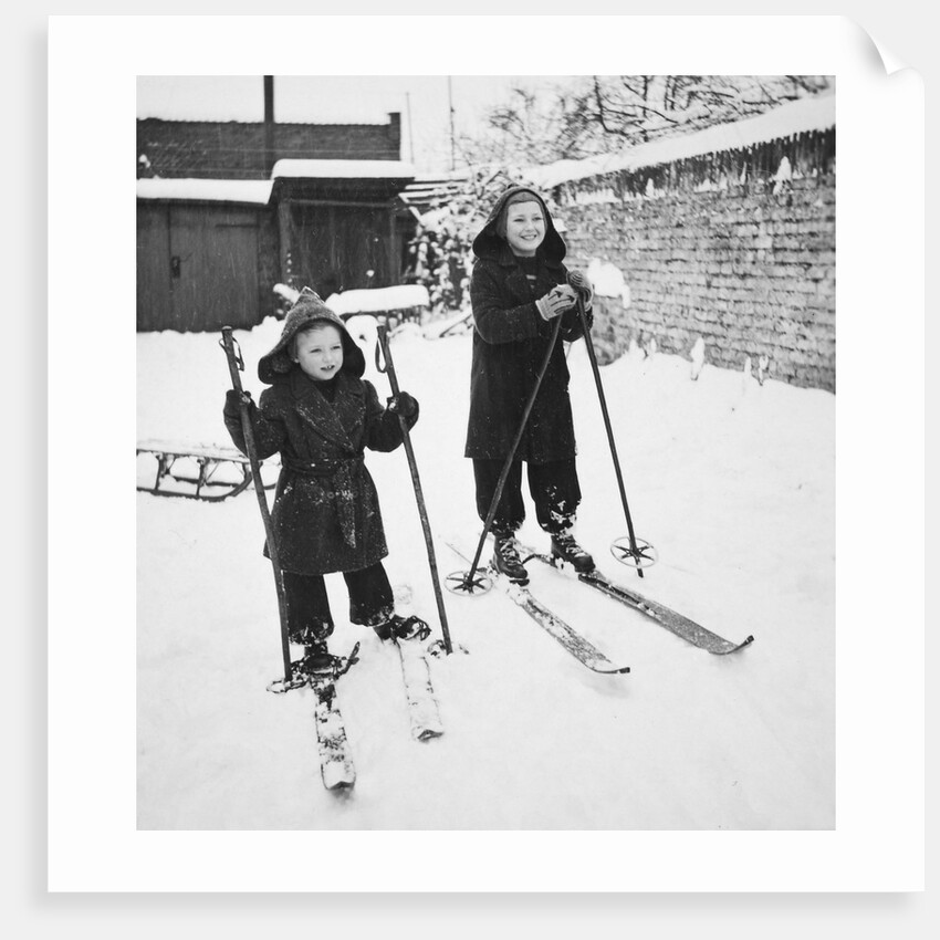 Two brothers stand on their skis in the snow, ca. 1950 by Anonymous