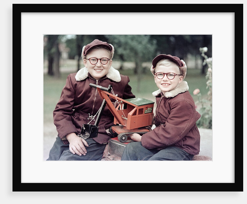 Two brothers play with a Buddy L steam shovel toy in Wisconsin, ca. 1953 by Anonymous