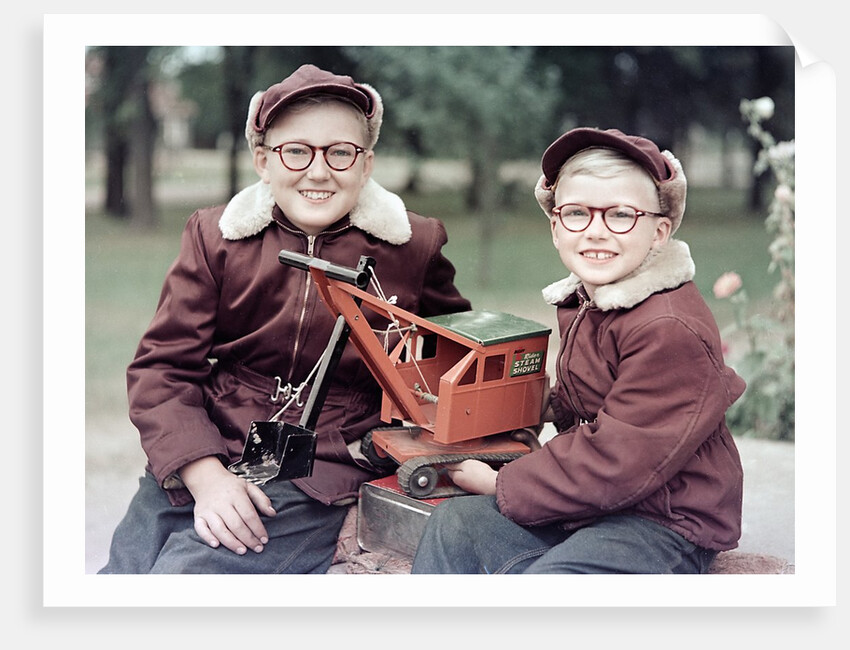 Two brothers play with a Buddy L steam shovel toy in Wisconsin, ca. 1953 by Anonymous
