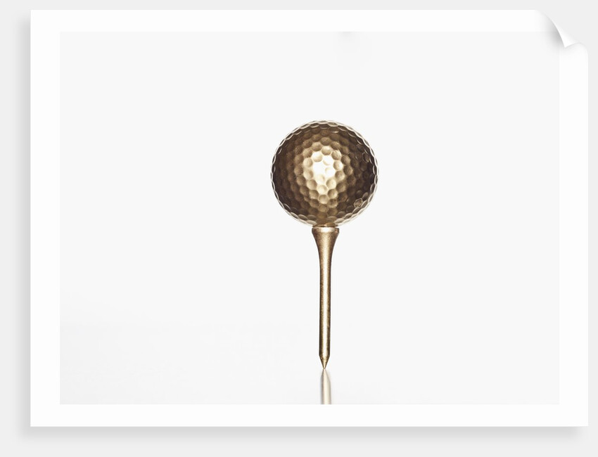 Gold golf ball and tee by Anonymous