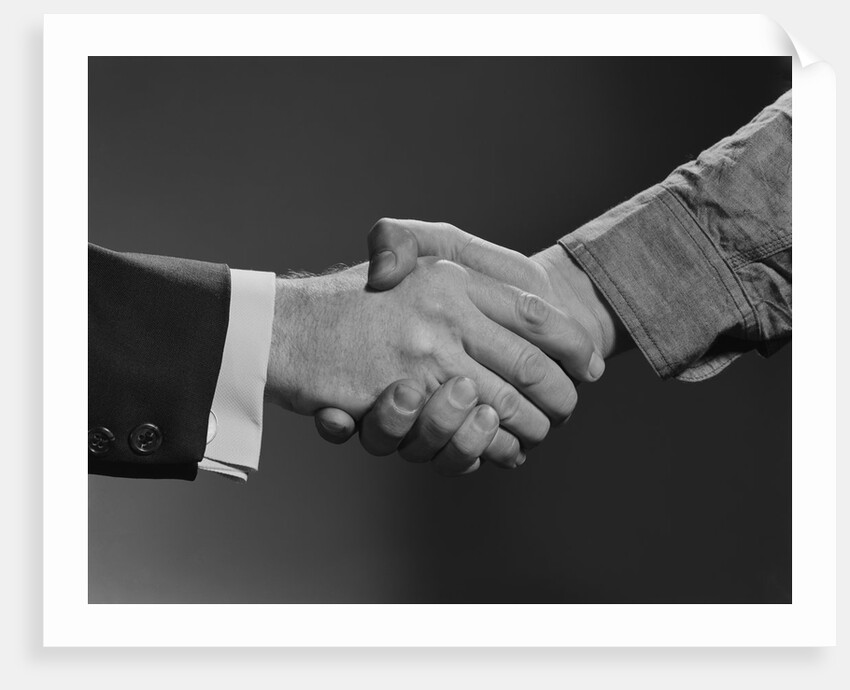 Close-up handshake between businessman and laborer by Anonymous