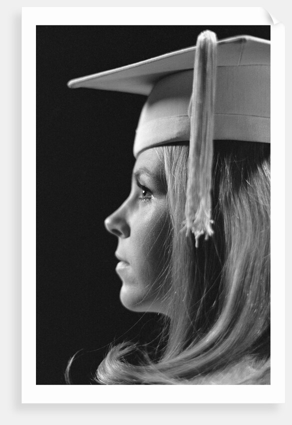 Profile blond female graduate wearing white mortarboard by Anonymous