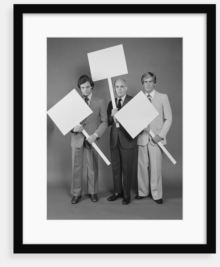 Trio of businessmen carrying blank signs by Anonymous