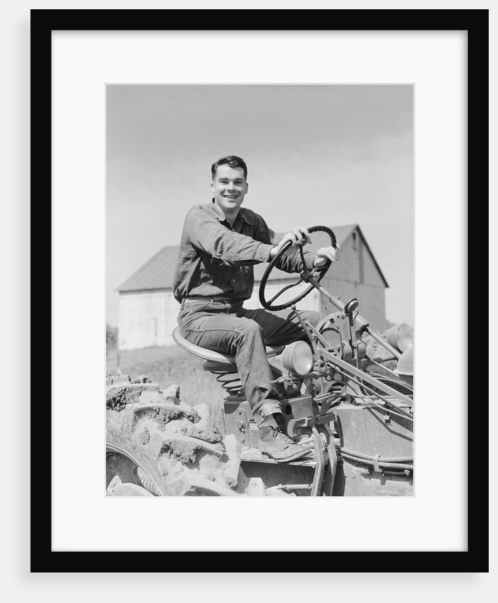 Smiling man farmer driving tractor by Anonymous