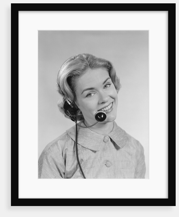 Smiling woman telephone operator wearing headset by Anonymous