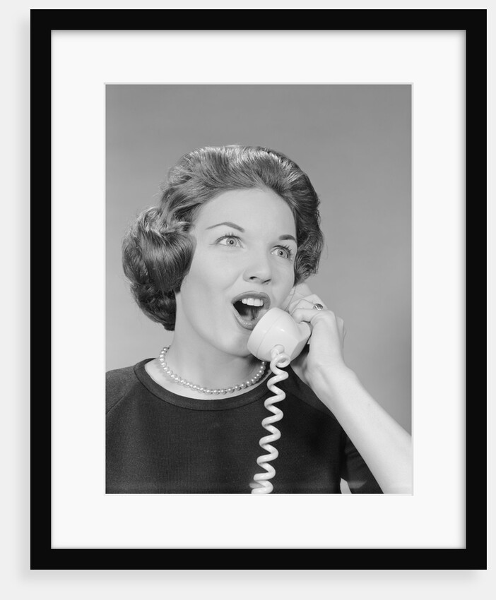 Excited woman talking on telephone by Anonymous