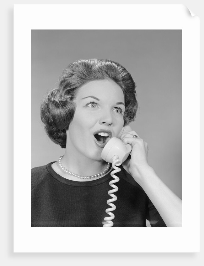 Excited woman talking on telephone by Anonymous