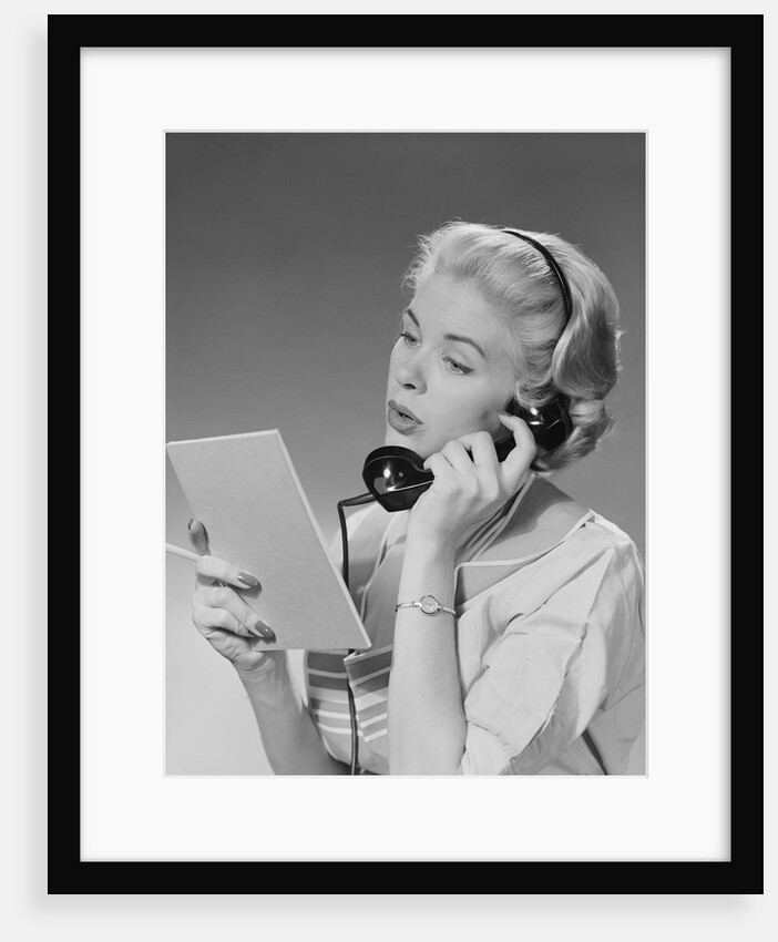 Blond woman talking on telephone reading list by Anonymous
