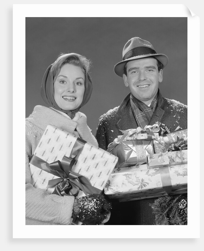 Couple man and woman holding wrapped christmas presents and packages by Anonymous