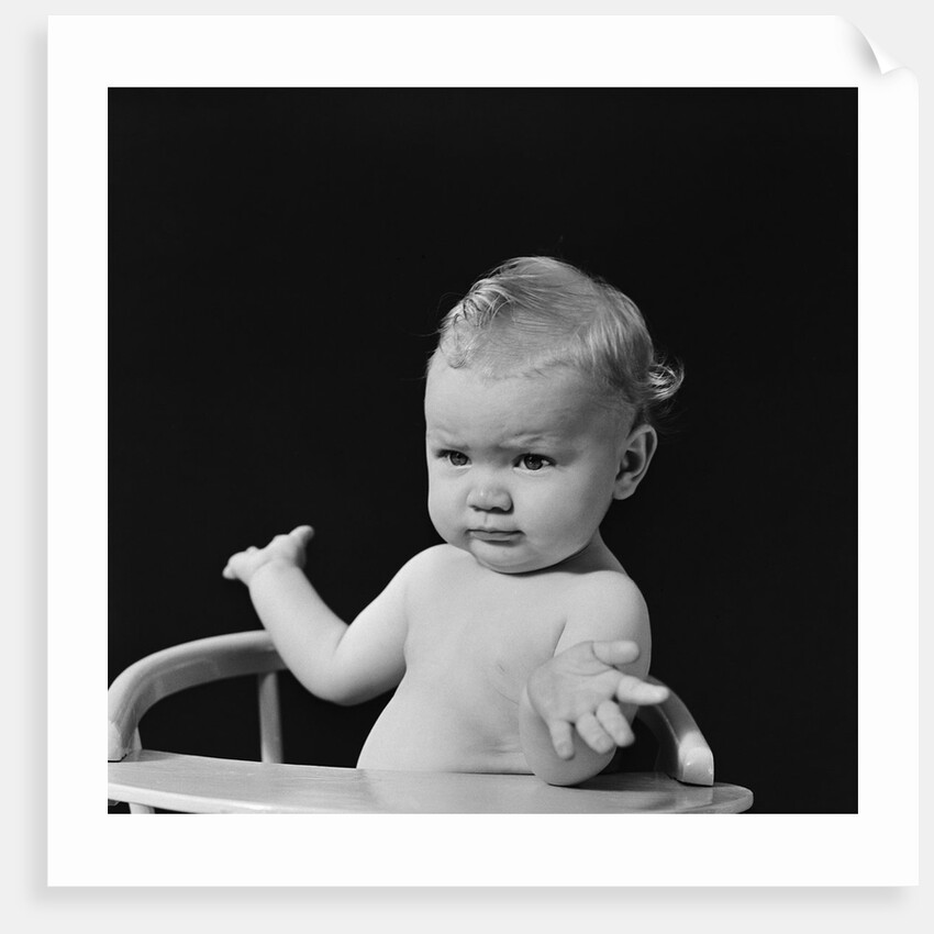 Baby in high chair making shrugging gesture by Anonymous