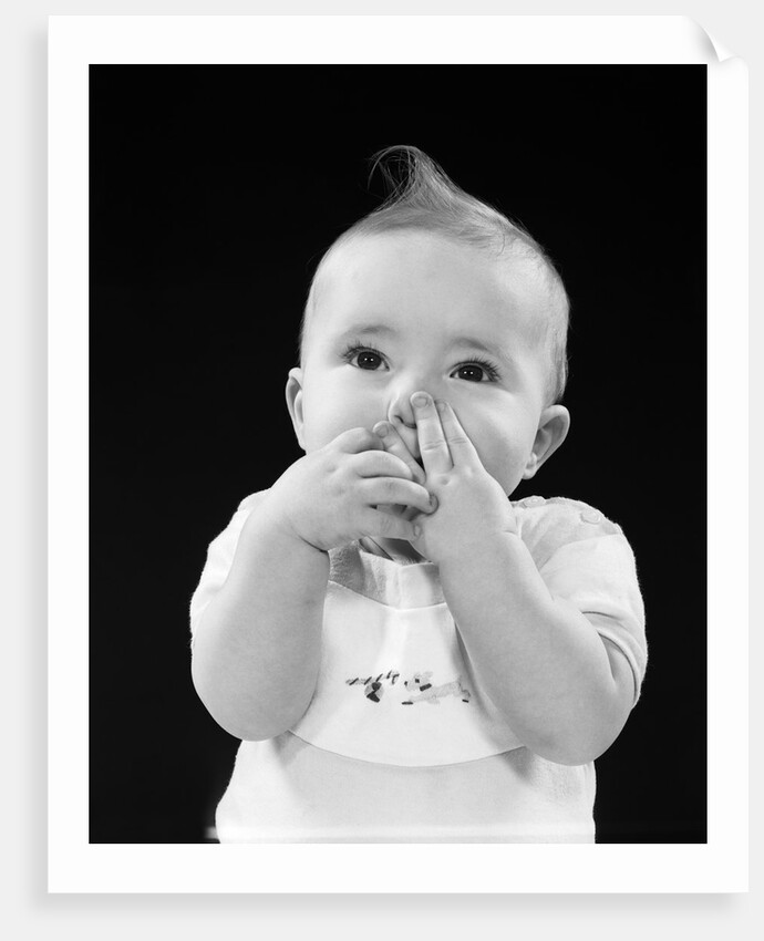 Portrait of baby covering mouth with hands fingers by Anonymous