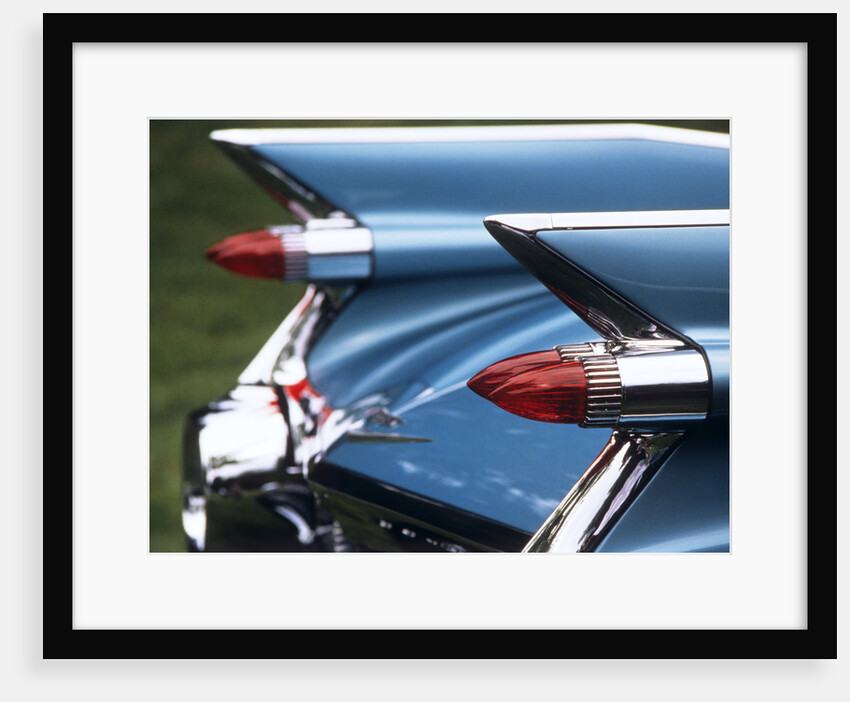 Detail fins rear tail lights blue cadillac auomobile by Anonymous