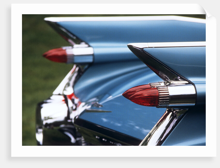 Detail fins rear tail lights blue cadillac auomobile by Anonymous