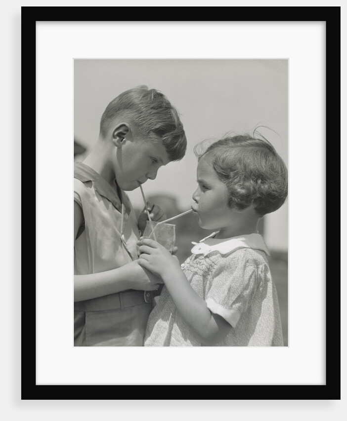 Children boy girl sharing drinking glass using straws by Anonymous