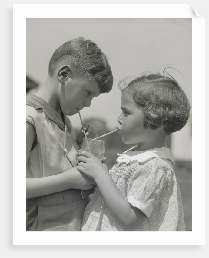 Children boy girl sharing drinking glass using straws by Anonymous