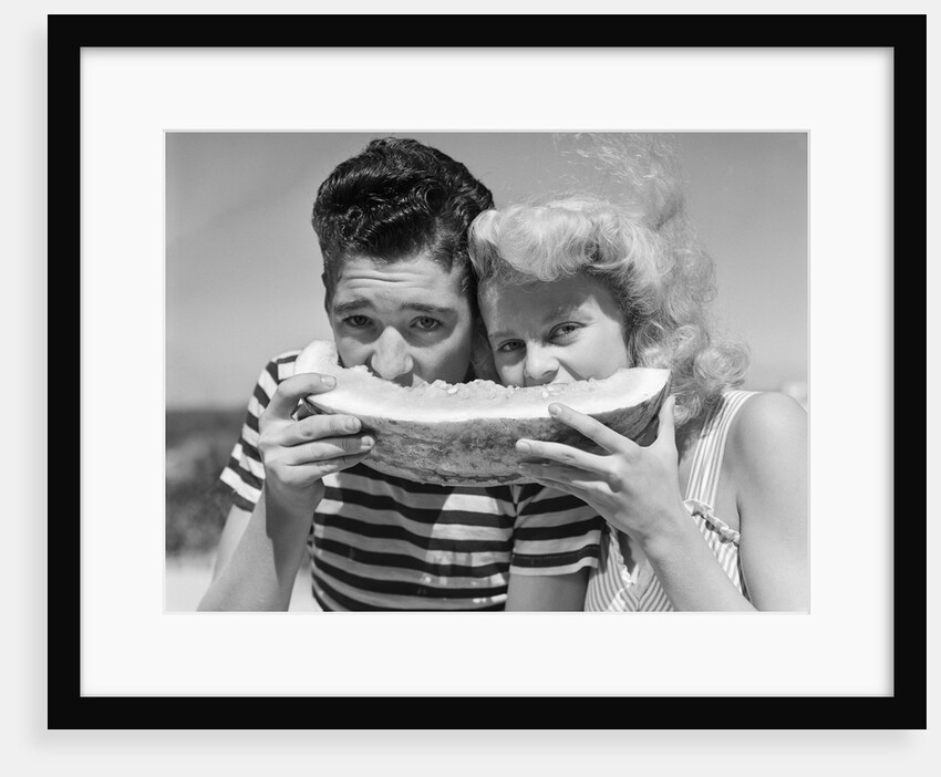 Teen age boy & girl eating slice watermelon by Anonymous