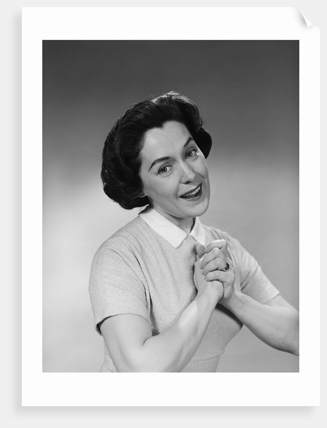 Brunette woman smiling happy satisfied proudly clasping hands to chest by Anonymous