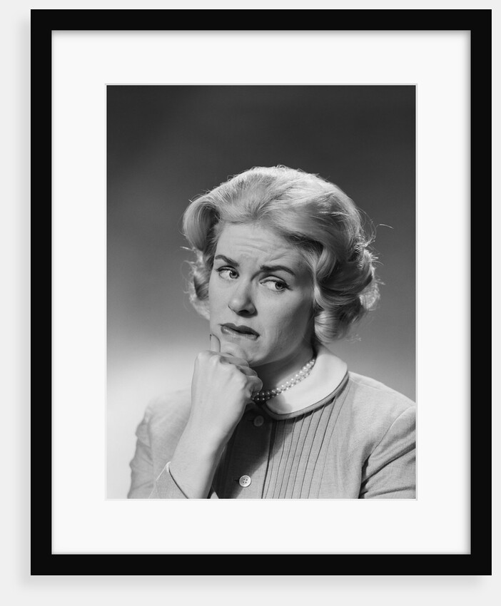 Blonde woman fist to chin worried serious facial expression by Anonymous