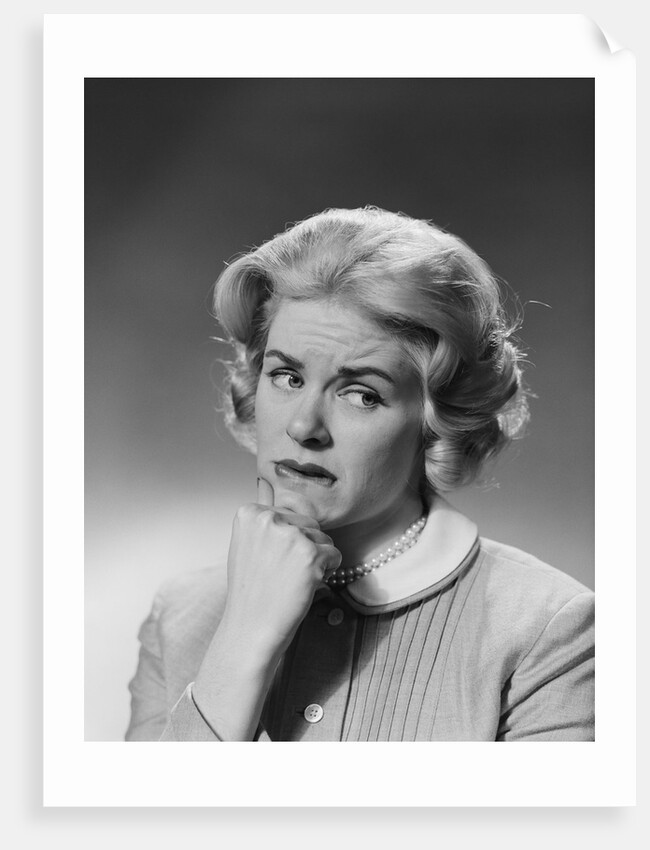 Blonde woman fist to chin worried serious facial expression by Anonymous
