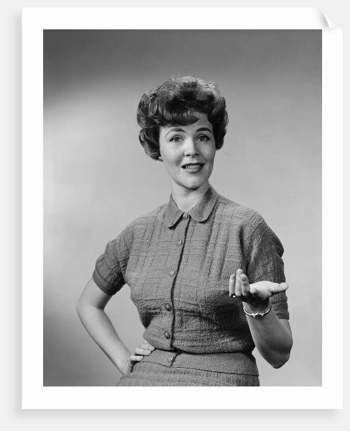 Brunette woman knit dress offhand gesture serious expression by Anonymous