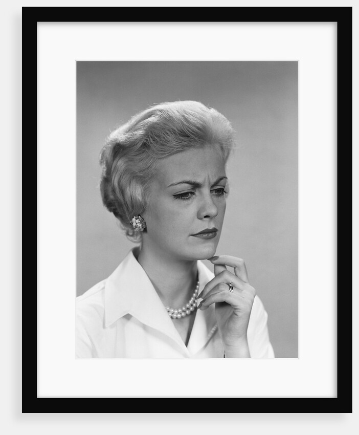Blond woman pearl necklace worried concerned facial expression by Anonymous