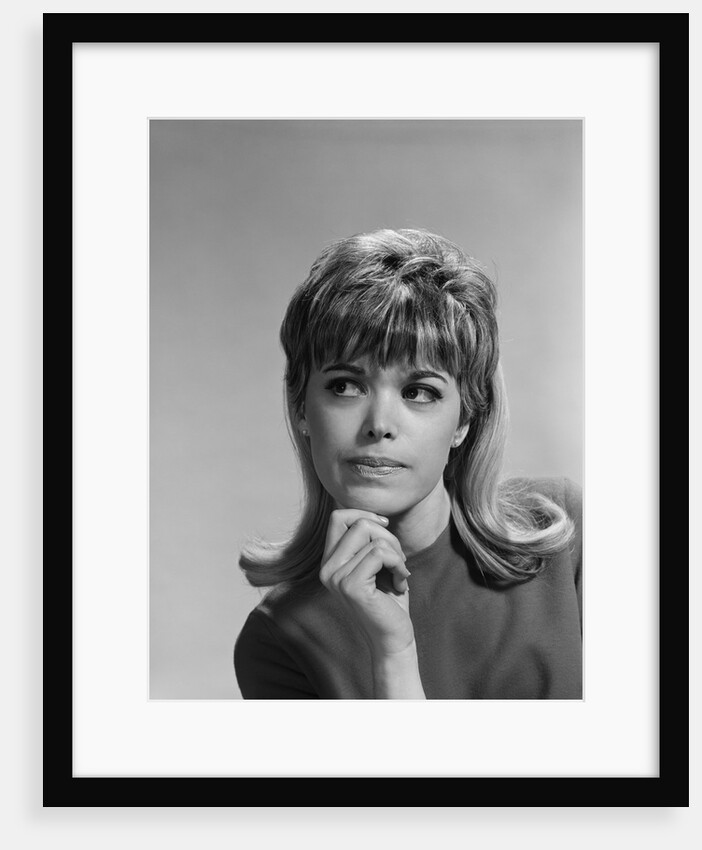 Portrait woman hand to chin bored facial expression by Anonymous