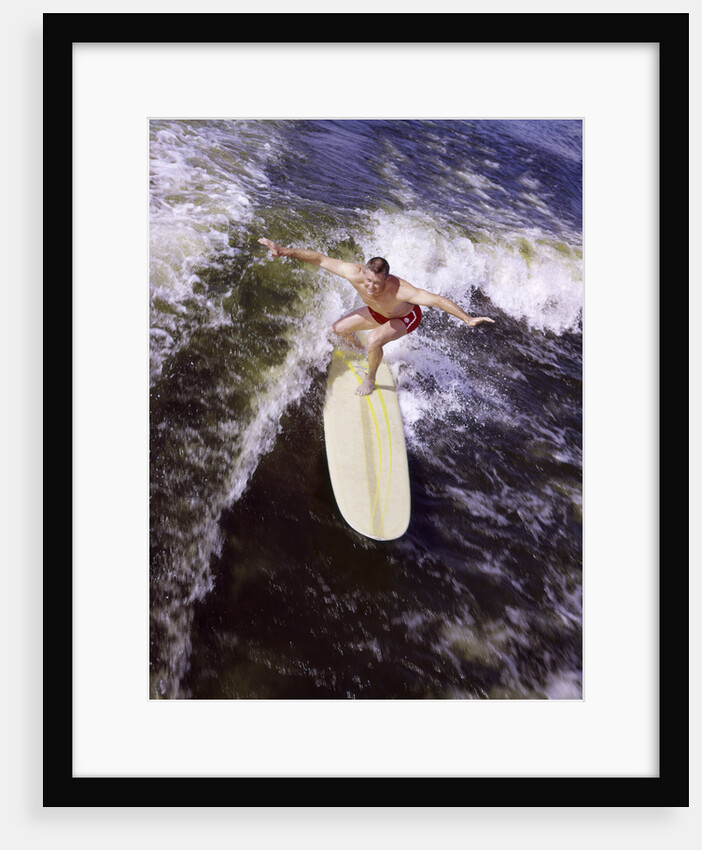 Young man red swim trunks yellow surfboard riding a wave surfing by Anonymous