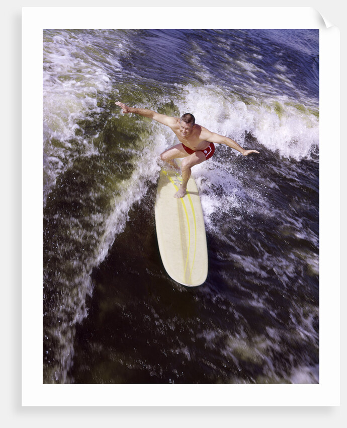 Young man red swim trunks yellow surfboard riding a wave surfing by Anonymous