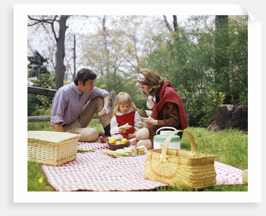 Family mother father girl spring picnic on checkered tablecloth by Anonymous