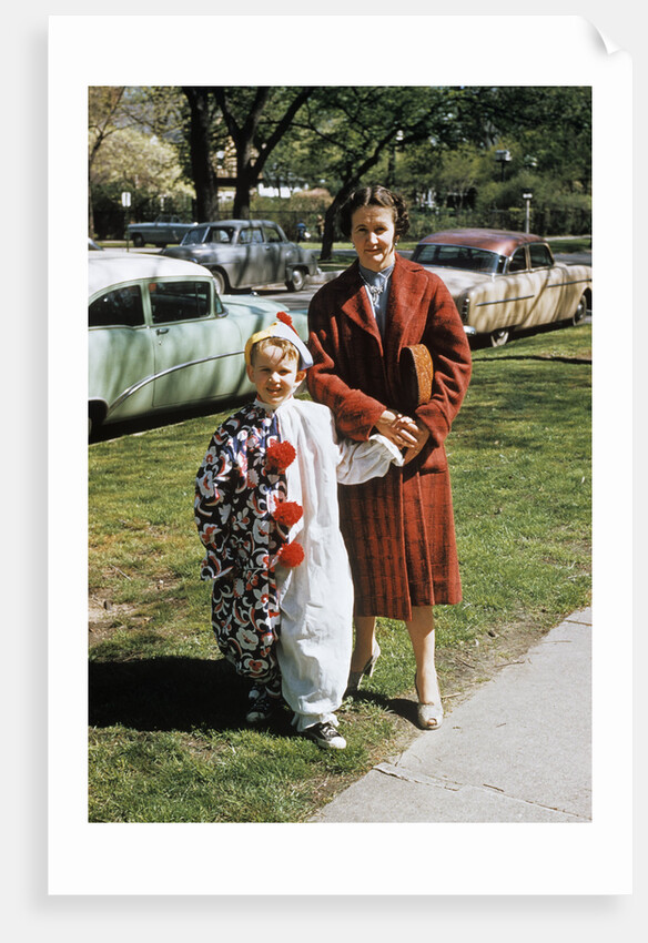 Mother with son dressed in clown suit outdoors by Anonymous