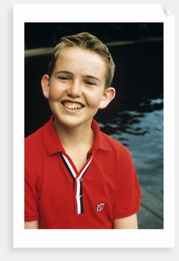 Portrait young boy in red shirt smiling by Anonymous