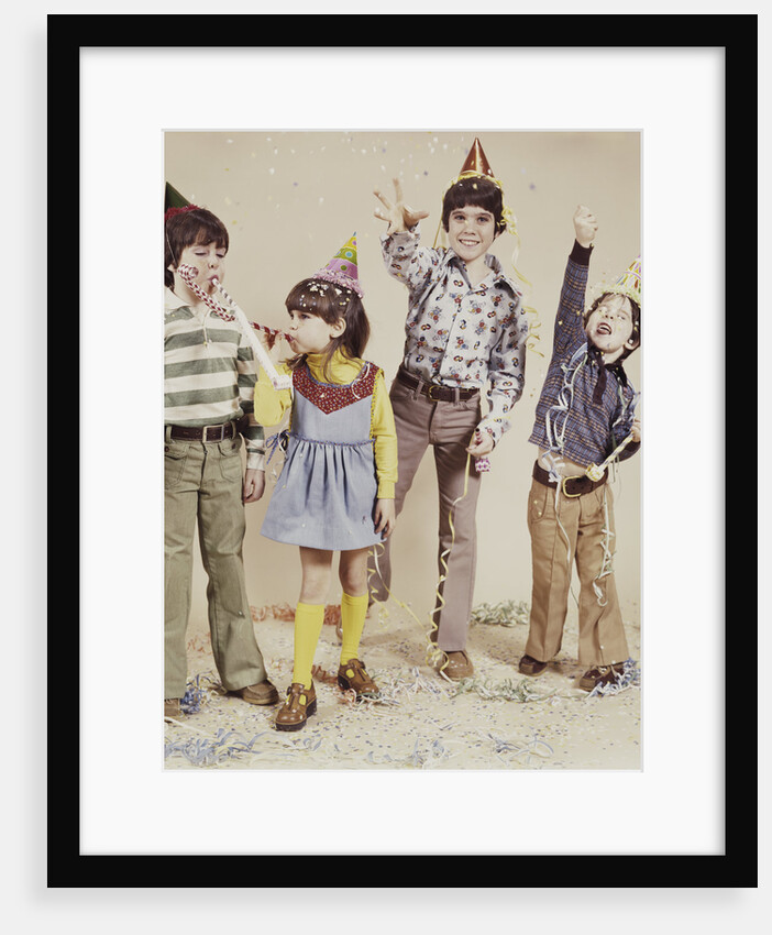 4 kids wearing party hats tossing confetti by Anonymous