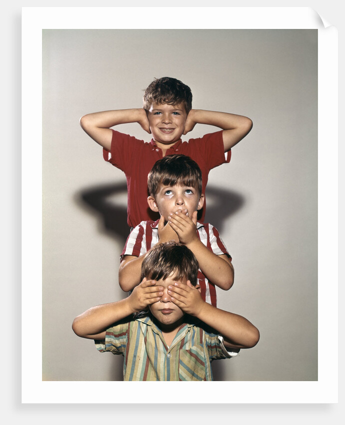 Boys posing as three wise monkeys see no evil hear no evil speak no evil by Corbis