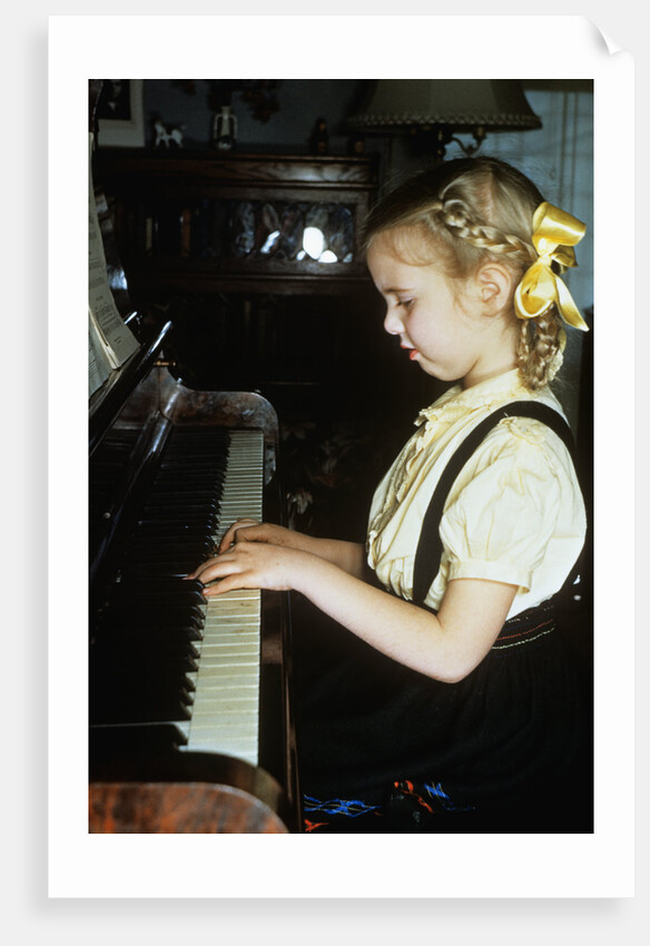 Little blond girl playing practicing the piano by Anonymous
