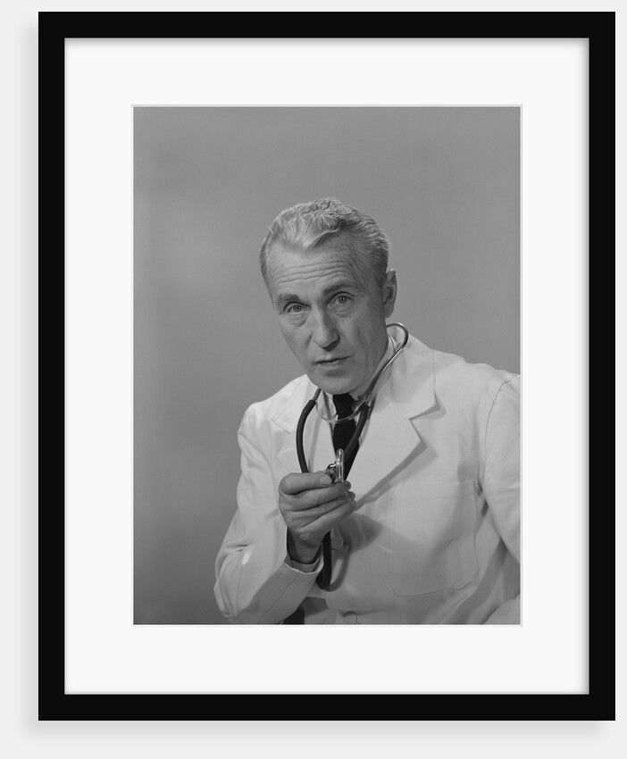 Male doctor holding stethoscope by Anonymous