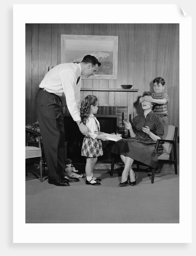 Family living room woman mother getting surprise gift from children daughter son husband by Anonymous