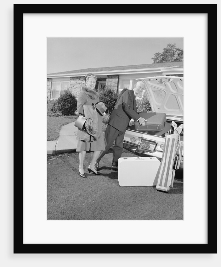 Senior man woman husband wife packing trunk with luggage by Anonymous