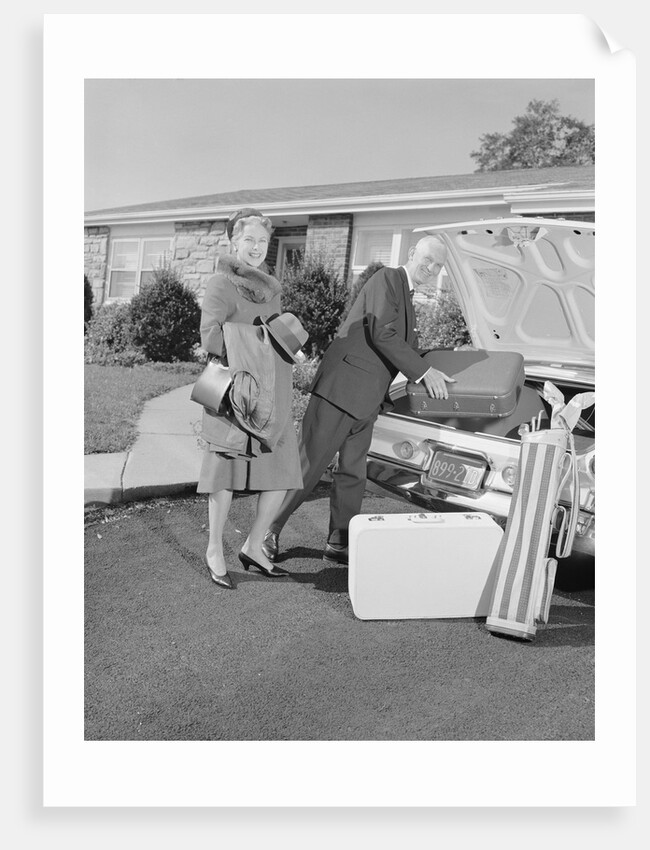 Senior man woman husband wife packing trunk with luggage by Anonymous