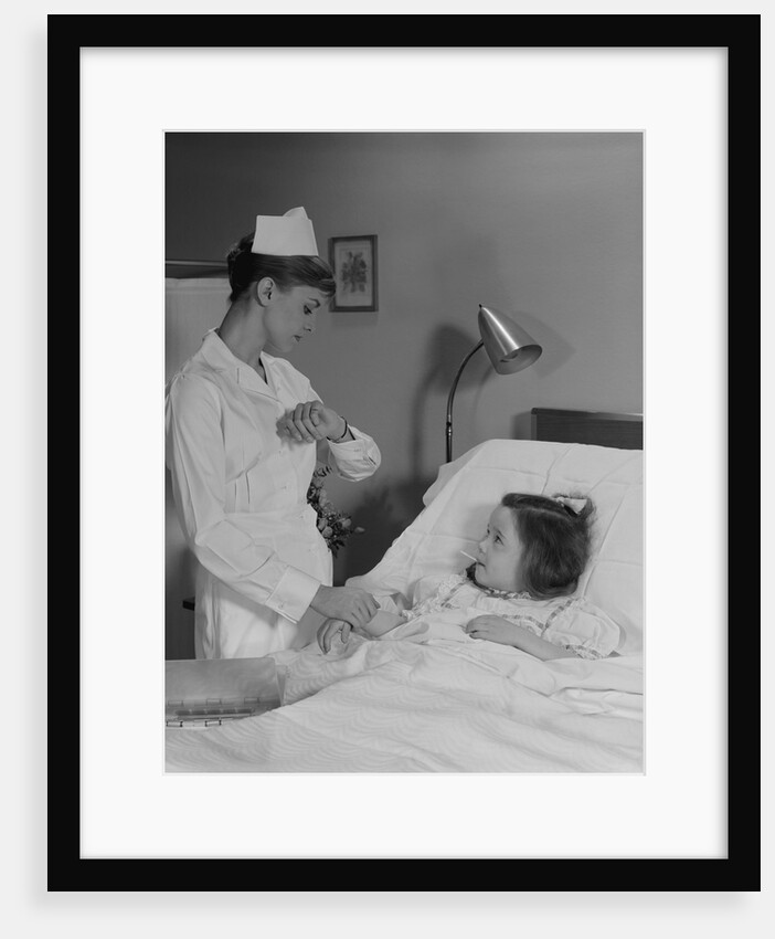 Woman nurse checking pulse taking temperature on little girl patient in hospital bed by Anonymous